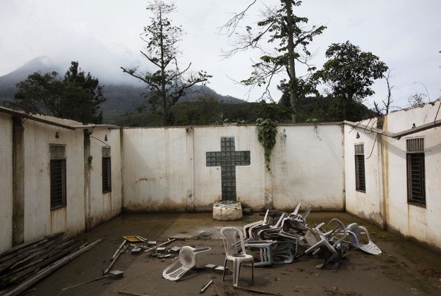 In this Friday, Nov. 13, 2015 photo, chairs are strewn across a church which was abandoned following the eruption of Mount Sinabung in the village of Kuta Gugung, North Sumatra, Indonesia. Crumbling buildings and personal belongings left behind now serve as eerie reminders of how life suddenly stopped when the volcano erupted and everyone was forced to evacuate their homes. 