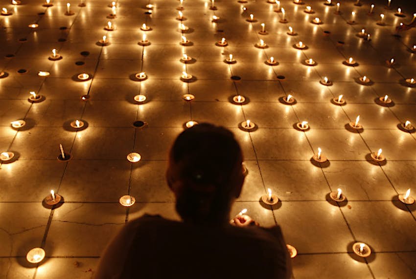 Travel News - photo6 A Buddhist devotee lights candles in Aung Daw Mu Temple marking the full moon day of Thadingyut, the lighting festival to celebrate the end of Buddhist Lent in Mandalay, Myanmar, Wednesday 28 October.