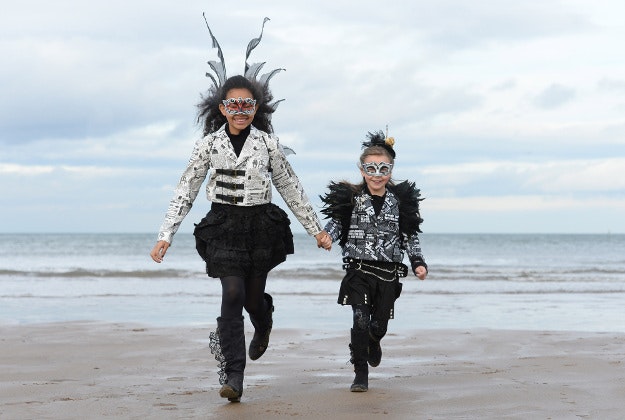 Tia, 12, and Roxy, 6, from Huddersfield run on the beach during the Whitby Goth Weekend in Whitby, North Yorkshire.