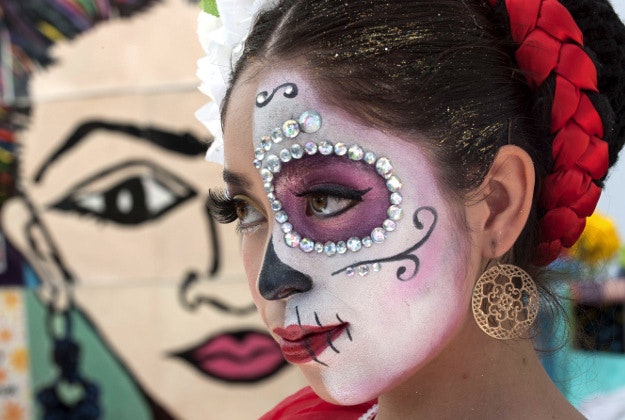 Mary Triana, 16, wears an intricate Day Of The Dead face at the first annual "Viva la Vida" festival at the Santa Ana, Calif., train station Sunday, Nov. 1, 2015.The first annual "Viva la Vida" festival was a celebration of Day of the Dead (Dia De Los Muertos) at the Santa Ana Train Station. The event featured individual alters to ancestors, food and entertainment.