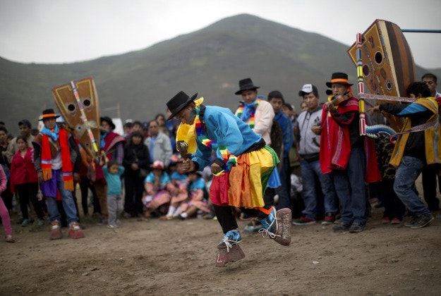 A man performs an indigenous dance called Huaylia at the Virgen de Lourdes cemetery where relatives converge to honor friends and family who have passed, marking the Day of the Dead holiday, in Lima, Peru, Sunday, Nov. 1, 2015. The souls of departed loved ones are being honored around Latin America as celebrants blend pre-Columbian rituals with the Roman Catholic observance of all Saint's Day on Nov. 1 and All Soul's Day on Nov. 2 to mark the Day of the Dead. 