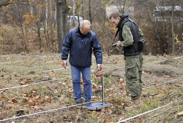 Workers using a radar detector check the area where, according to two explorers, a World War II Nazi train with armaments and precious minerals is allegedly hidden in an underground tunnel in Walbrzych, Poland,Tuesday, 10 November.