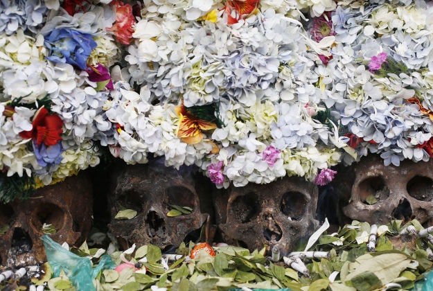 Human skulls or "natitas" crowned with flowers are surrounded by offerings of coca leaves, flower petals and cigarettes, outside the Cementerio General chapel during the Natitas Festival, in La Paz, Bolivia. 