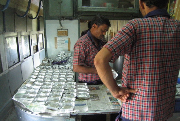 Men prepare food in a pantry car