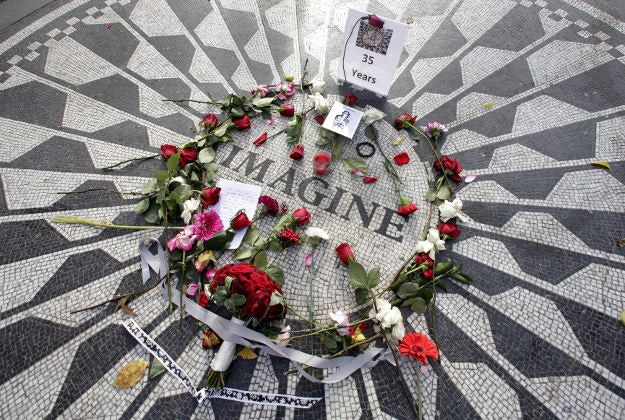 Flowers adorn the Imagine mosaic in remembrance of John Lennon, in the Strawberry Fields section of New York's Central Park, Tuesday, Dec. 8, 2015. Thirty-five years ago, Mark David Chapman shot and killed the former the Beatle. 