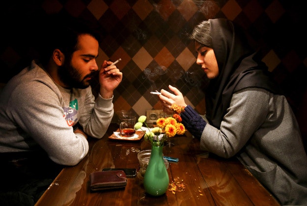 An Iranian man and a woman enjoy their time at a cafe in downtown Tehran, Iran, Tuesday, Dec. 8, 2015. 