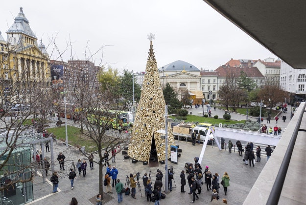 A huge, 16-meter high Christmas tree erected by Hello Wood, a Budapest based international educational platform of design and architecture and a design studio, stands after its inauguration in a square in central Budapest, Hungary, Tuesday, Dec. 8, 2015. The tree with a basic area of 30 square meters was built of 40 tons of firewood that will be distributed among the poor after the holiday.