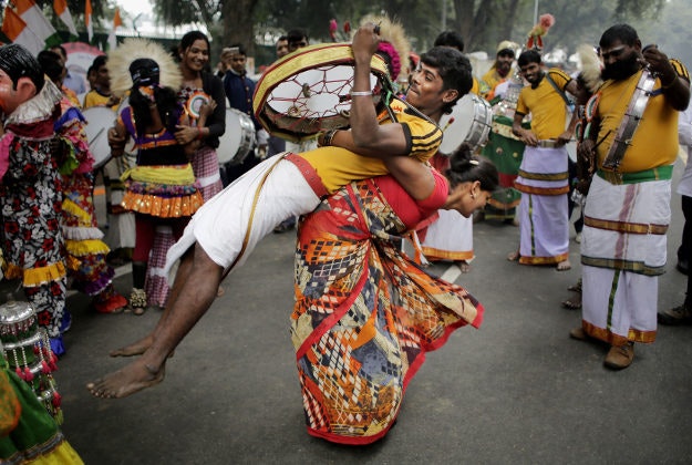 Tribal artists and supporters from the southern Indian state of Karnataka dance outside the residence of Congress Party President Sonia Gandhi during her birthday celebrations in New Delhi, India, Wednesday, Dec. 9, 2015. The Italian-born Gandhi is the widow of former Prime Minister Rajiv Gandhi and has led the Congress party since 1998. 