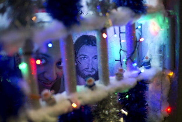 A prisoner looks through the bars of her cell during a Christmas decorating contest at the Nelson Hungria prison in Rio de Janeiro, Brazil, Thursday, Dec. 10, 2015. Each cell of 50 women or more also put on a skit dramatizing Biblical stories, with many depictions of Jesus' life, as well as David and Goliath and Daniel in the lions? den, giving prison?s would-be thespians their chance to shine. Voices soared in rapture with the religious songs, and many, many tears were shed. 