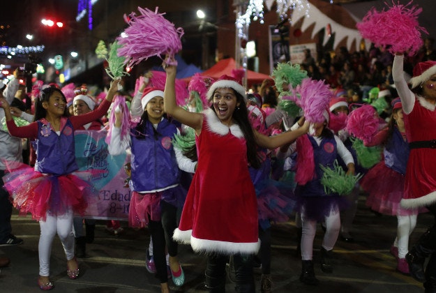 Women dressed as Santa Claus take smile and dance during the annual Christmas Parade in La Paz, Bolivia, Saturday, Dec. 12, 2015. Hundreds of people took part inthe parade, costumed up as Santa Claus, elves, angels, included floats and marching bands. 