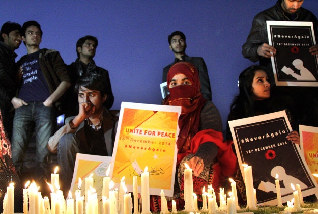 Members of a non-government organization 'Bargad' hold a candle light vigil in connection with upcoming first anniversary of the Peshawar school attack, Sunday, Dec. 13, 2015 in Lahore, Pakistan. Pakistani Taliban militants attacked an army-run school in Peshawar, killing 150 people, mostly children on Dec. 16. 2014.