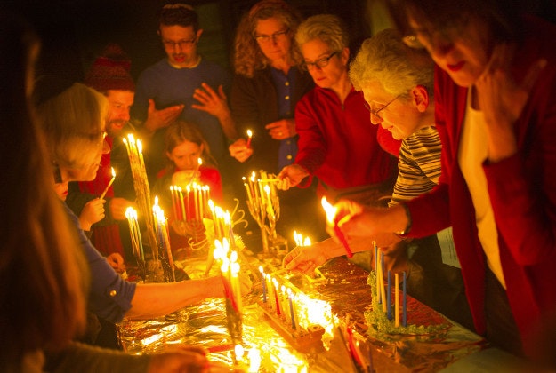 Members of the Mayim Rabim Congregation celebrate Hannukah by lighting menorahs on Sunday, Dec. 13, 2015, in Minneapolis. 