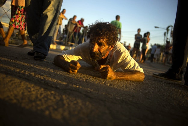 A man crawls as self-imposed penance during a pilgrimage to the shrine of St. Lazarus, in El Rincon, near Santiago de las Vegas, Cuba, Wednesday, Dec. 16, 2015. Lazarus also is identified as the Yoruba deity Babalu Aye - the protector of the sick who took upon himself all the illnesses of his people to save them. 