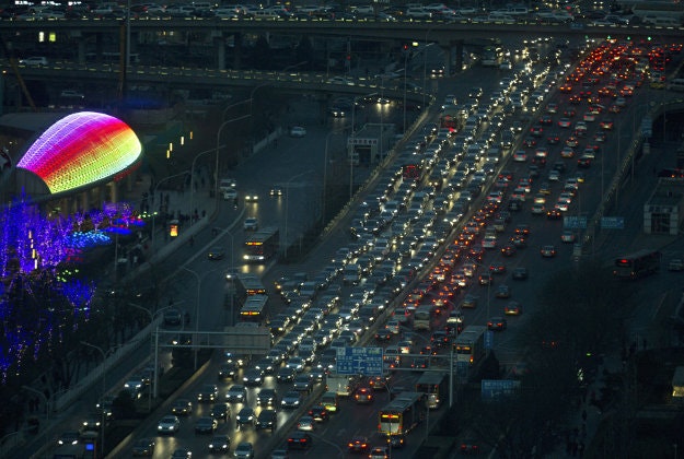 Cars clog a main road during peak hour in Beijing Friday, Dec. 18, 2015. Residents in the Chinese capital are preparing for its second smog red alert as a wave of smog is forecasted to settle over the city from Saturday to Tuesday.
