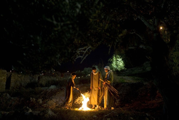 Israeli Arab Christians set up bonfire during a re-enactment of a Nativity scene part of Christmas festivities at the Nazareth Village in the northern Israeli city of Nazareth, Tuesday, Dec. 22, 2015. 
