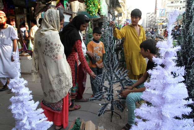 Pakistani Christians buy items for the upcoming Christmas holiday in Karachi, Pakistan, Wednesday, Dec. 23, 2015. 