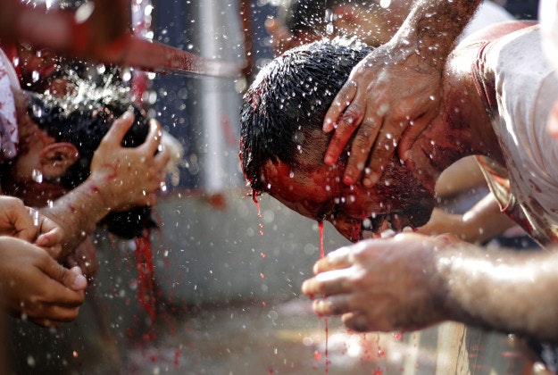 Bahraini Shiite Muslims wash up after flagellating themselves with swords as part of the Arbaeen ritual in Muharraq, Bahrain, Thursday, Dec. 3, 2015. The holiday marks the end of the forty day mourning period following the anniversary of the 7th century martyrdom of Imam Hussein, the Prophet Muhammad's grandson. 