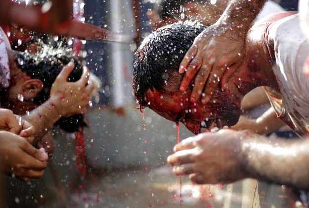 Bahraini Shiite Muslims wash up after flagellating themselves with swords as part of the Arbaeen ritual in Muharraq, Bahrain, Thursday, Dec. 3, 2015. The holiday marks the end of the forty day mourning period following the anniversary of the 7th century martyrdom of Imam Hussein, the Prophet Muhammad's grandson.