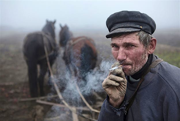Travel News - TPOTY 2015 Faces, People, Encounters, Winner, Mitchell Kanashkevich (Australia) Maramures, Romania Hungarian-Romanian man takes a break from ploughing a field.