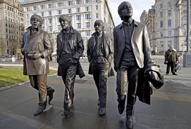 A new Statue of the Beatles is unveiled by John Lennon's sister Julia Baird outside the Liverbuilding, in Liverpool.