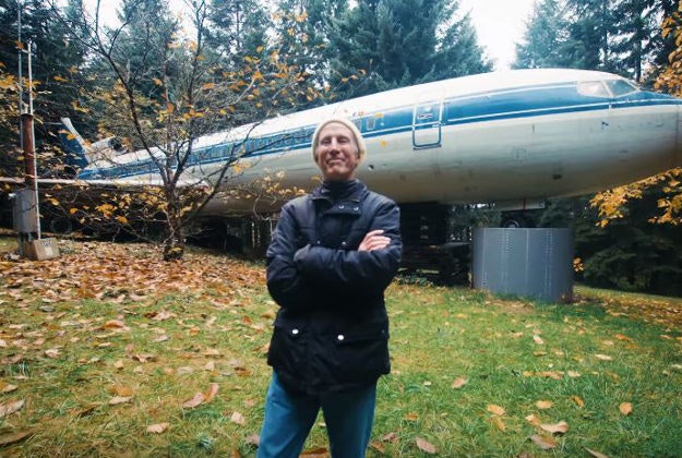 Bruce Campbell stands outside his airplane home.