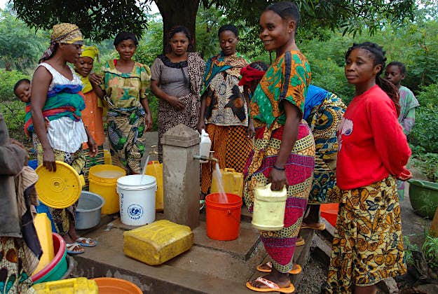 Travel News - cholera Women around a water pipe producing clean cholera free water
