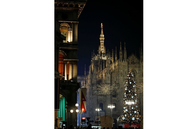 A Christmas tree stands in front of the Duomo gothic cathedral in Milan, Italy, Wednesday, Dec. 16, 2015. 