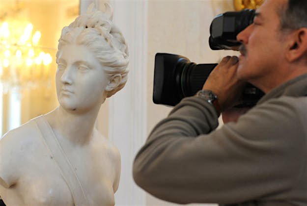 Travel News - looted nazi bust 3 A cameraman records the marble bust of the antique goddess Diana during a ceremony of return at the Lazienki Palace in Warsaw, Poland, Friday, Dec. 18, 2015. The 18th-century marble bust of the goddess Diana looted by the Nazis in 1940 has returned to Warsaw from Vienna, where it recently surfaced at an auction house.