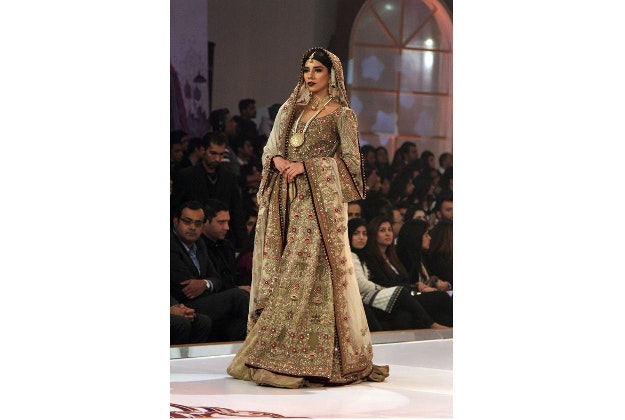 A model presents a creation by Pakistani designer Fahad Hussan during the last day of Telenor Bridal Couture Week in Lahore, Pakistan, Sunday, Dec. 13, 2015.