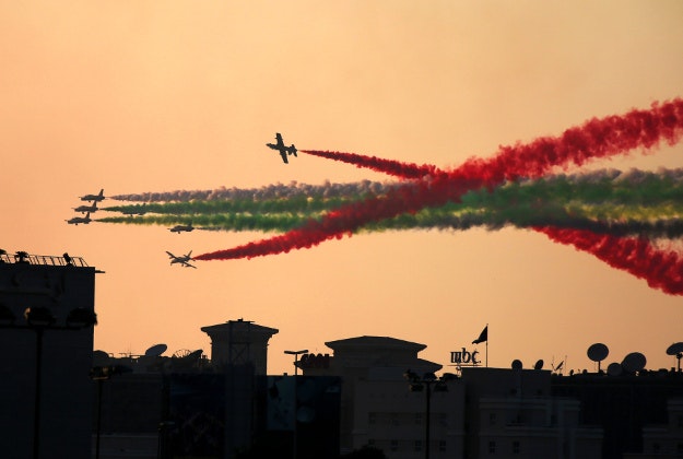 The Al Fursan aerobatic team flies over Dubai Media City on Thursday, Dec. 3, 2015, as part of the World Air Games in Dubai, United Arab Emirates. 