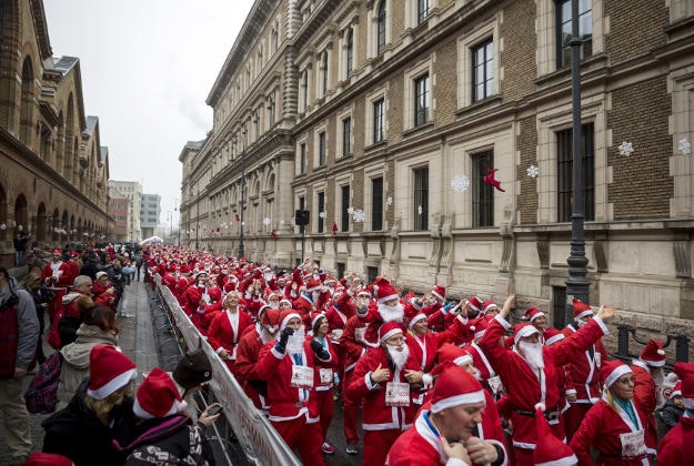People wearing Santa Claus costumes participate in the Santa Run in Budapest, Hungary, Sunday, Dec. 6, 2015.
