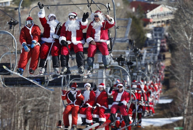 Skiers and snowboarders dressed as Santa ride a chairlift while participating in Santa Sunday at the Sunday River ski resort, Sunday, Dec. 6, 2015, in Newry, Maine. The resort hosted 150 Santas who raised $3,014 for the Sunday River Community Fund. 