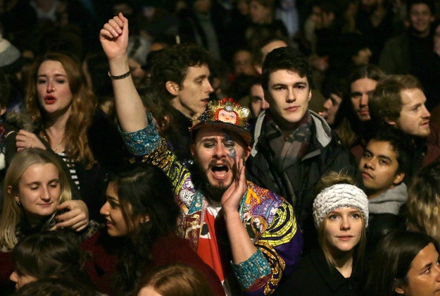 People dance and sing to music by British singer David Bowie on Windrush Square in Brixton, south London, Monday, Jan. 11, 2016. Bowie, the other-worldly musician who broke pop and rock boundaries with his creative musicianship, nonconformity, striking visuals and a genre-spanning persona he christened Ziggy Stardust, died of cancer Sunday aged 69. He was born in Brixton. 