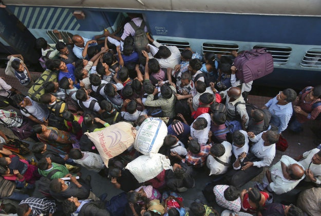 Indians scramble to enter a train in Hyderabad, India, Wednesday, Jan. 13, 2016. Railway platforms and trains were overcrowded Wednesday as most people travelled to their hometowns to celebrate the Hindu festival of Makar Sankranti that falls on Jan. 15. 