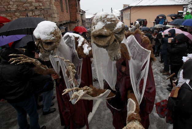Disguised revelers move along a snowy street during the carnival procession through the southwestern Macedonian village of Vevcani, on Wednesday, Jan. 13, 2016. Participants find an inspiration for their masks in the actual political events and perform various pagan rituals. In its fourteen centuries-old tradition, the Vevcani carnival is always held on St. Basil's day, marking the beginning of the New Year by the Julian calendar. 