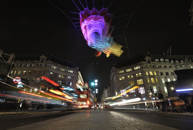 Art installation 1.8 London by Janet Echelman, suspended above Oxford Circus in London, as part of the Lumiere London light festival. The sculpture constructed from thousands of feet of twine is named after one of the impacts of the Japanese earthquake and tsunami in 2011, when the earth's rotation momentarily sped up and shortened that day by 1.8 microseconds. 