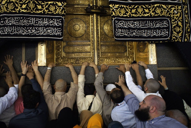 In this Wednesday, Jan. 13, 2016 photo, Muslim pilgrims pray in front of the door of the Kaaba, the cubic building at the Grand Mosque in the Muslim holy city of Mecca, Saudi Arabia for the minor pilgrimage, known as Umrah. 