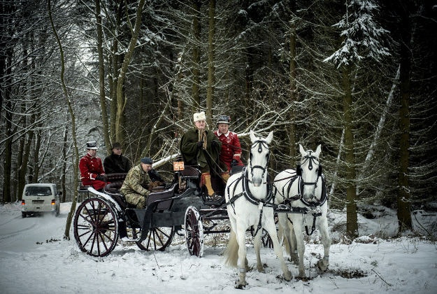 Denmark's Prince Henrik drives a coach with white horses on his way to a royal hunt in the forest of Grib Skov, Denmark, Thursday, Jan 14, 2016. 