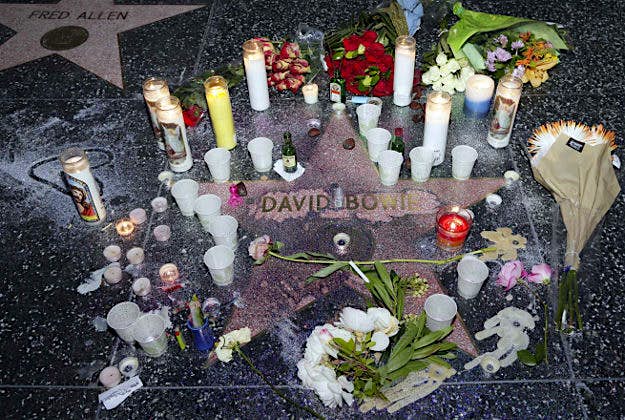 Travel News - 11 A makeshift memorial surrounds David Bowie's star on the Hollywood Walk of Fame in Los Angeles, Monday.