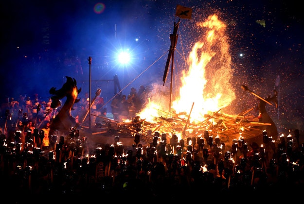 Members of the Jarl Squad dressed in Viking costumes carry flaming torches as the Galley burns, during the Up Helly Aa Viking festival in Lerwick on the Shetland Isles. Originating in the 1880s, the festival celebrates Shetland's Norse heritage and sees a 'Viking longship' dragged through the streets of Lerwick, led by a horde of people dressed as Vikings before being set alight. 