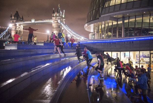 Participants exercise during a Project Awesome exercise session at the Scoop, City Hall, London. Project Awesome is a free fitness movement in London and uses a simple sense of accountability to motivate and encourage people of all ages, shapes, sizes and fitness levels to exercise at the Scoop and Primrose Hill.