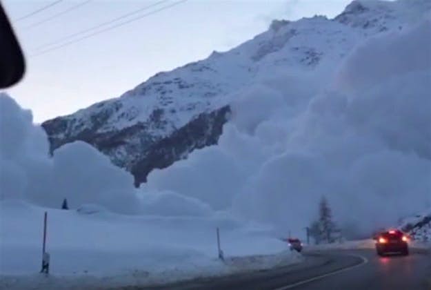 Travel News - Avalanche 2# Cars stop to watch the avalanche. Image by Screengrab via YouTube