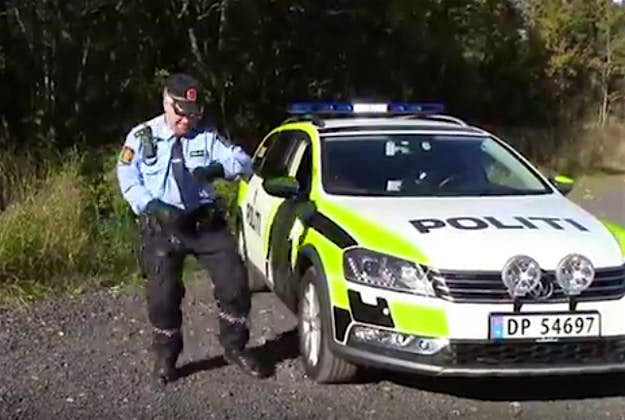 Travel News - Police2 Busting a move beside his cop car. Image by Screengrab via YouTube