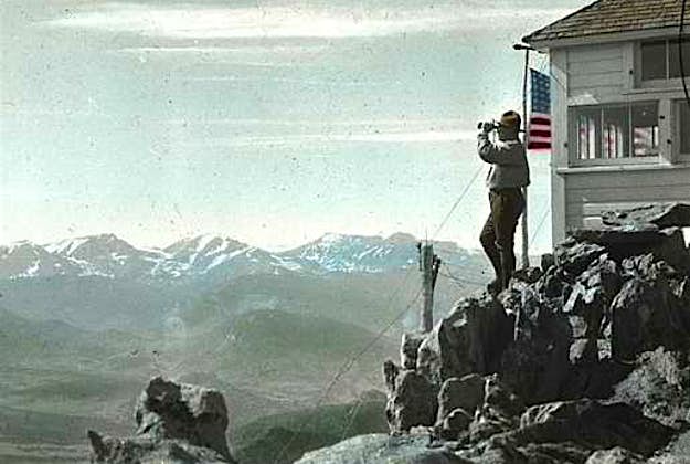 Travel News - hpc-001719 A photo taken in approximately 1916 in Rocky Mountain National Park in the USA, featuring Ranger Kesner at the Twin Sisters Peaks fire outlook.