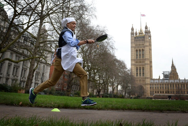 Norwich South MP Clive Lewis takes part the annual Rehab Parliamentary Pancake Race in which MPs, Lords and members of the media race each other on pancake day to raise money for the charity Rehab, in Victoria Tower Gardens, London. 