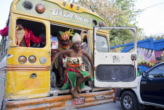 A Carnival dancer exits the back of a bus as she arrives for the last day of Carnival celebrations in Port-au-Prince, Haiti, Tuesday, Feb. 9, 2016. Political tensions haven't stopped the Haitian capital's annual Carnival, but the uncertainty led to the cancellation of the first day of festivities and put such a damper on the party that a number of top bands have pulled out. There have been relatively few decorated floats, a scarcity of sponsors and many Haitians say they are staying away from the capitalís annual celebration this year out of security concerns. 