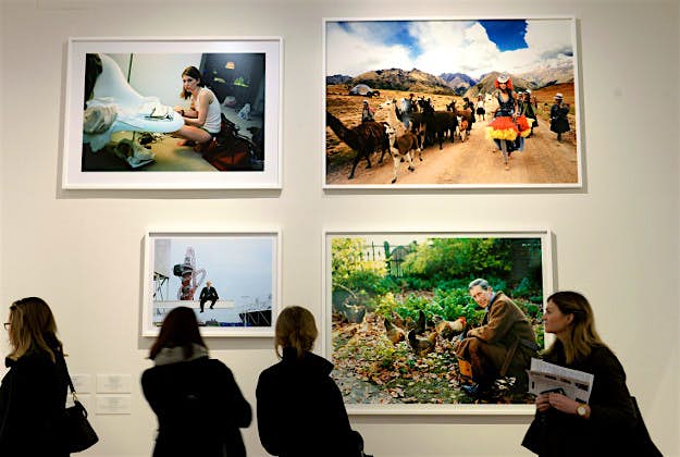 Travel News - 11137851-1 A woman views a selection of photographs during a press view.