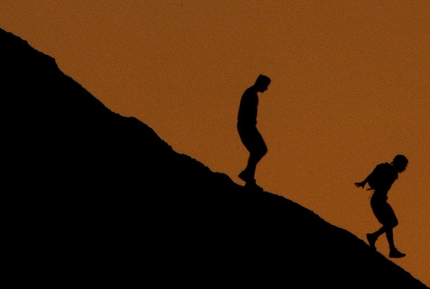 People hike down a hill in Papago Park at sunset Sunday, Feb. 21, 2016, in Phoenix.