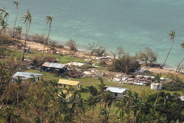 In this Sunday, Feb. 21, 2016 aerial photo supplied by the New Zealand Defense Force, debris is scattered around damaged buildings at Susui village in Fiji, after Cyclone Winston tore through the island nation. Fijians were finally able to venture outside Monday after authorities lifted a curfew but much of the country remained without electricity in the wake of a ferocious cyclone that left at least six people dead and destroyed hundreds of homes. 