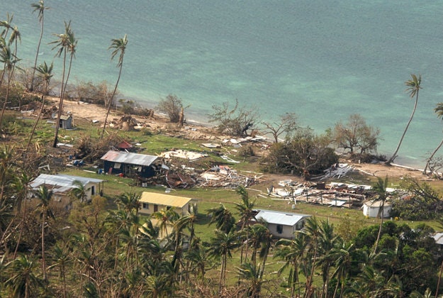In this Sunday, Feb. 21, 2016 aerial photo supplied by the New Zealand Defense Force, debris is scattered around damaged buildings at Susui village in Fiji, after Cyclone Winston tore through the island nation. Fijians were finally able to venture outside Monday after authorities lifted a curfew but much of the country remained without electricity in the wake of a ferocious cyclone that left at least six people dead and destroyed hundreds of homes.